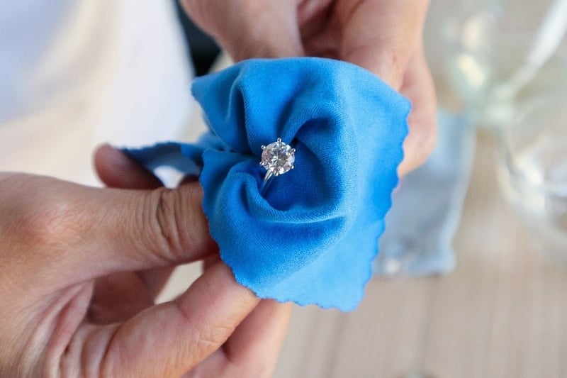 diamond ring being held in cleaning cloth